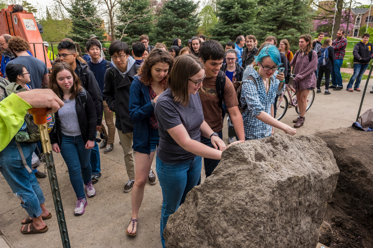 A new generation of Grinnell students makes the Peace Rock’s acquaintance. Photo by Justin Hayworth.