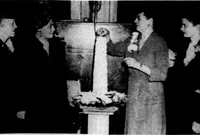 Mrs. Roy C. Weagly, president of the Associated Women of the American Farm Bureau Federation, lights a candle at the 1948 convention. Martha Day traveled regularly to conventions like these, held in Chicago and other large cities.