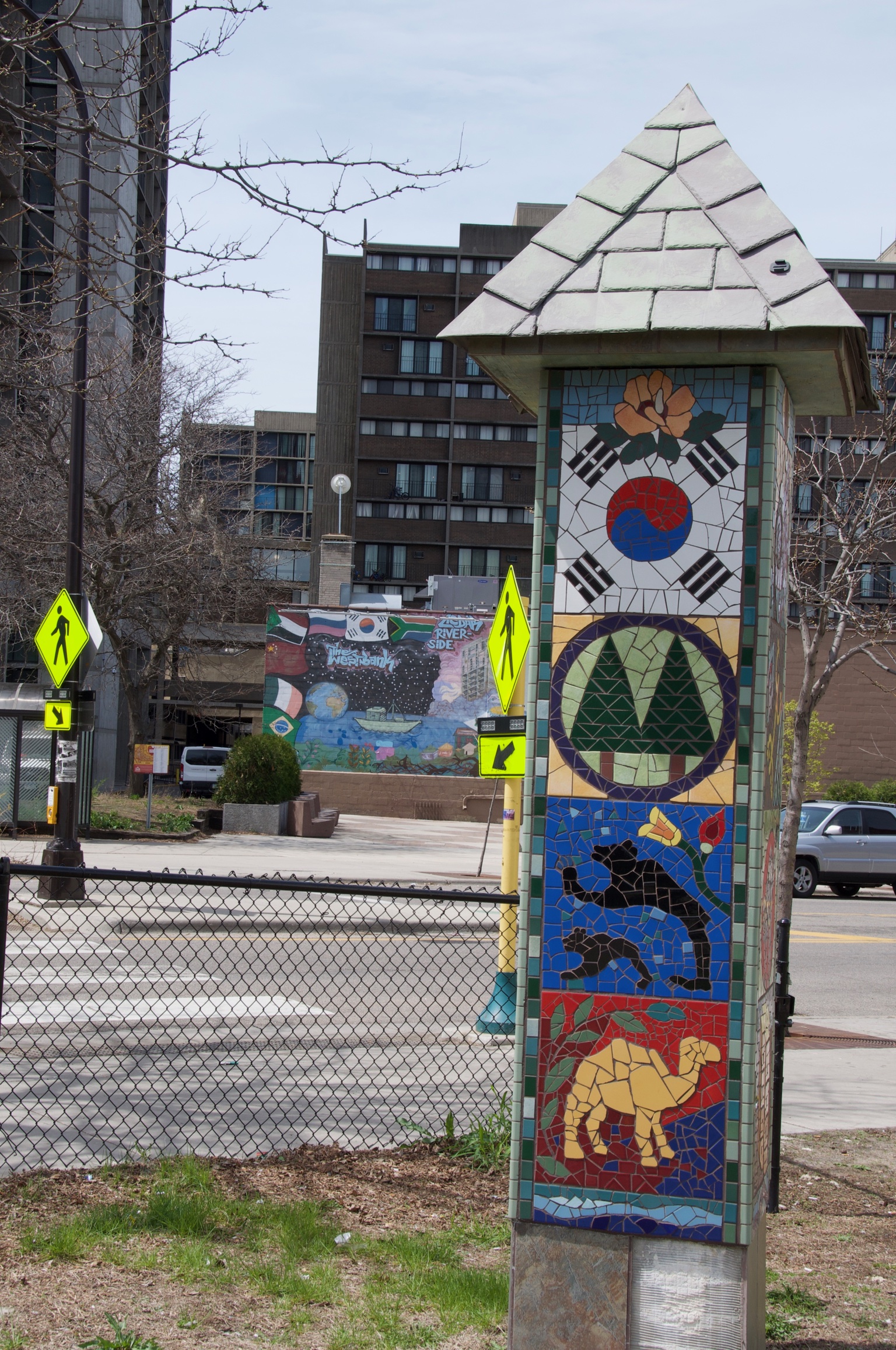 The mosaic signpost features images from varied cultures and environments