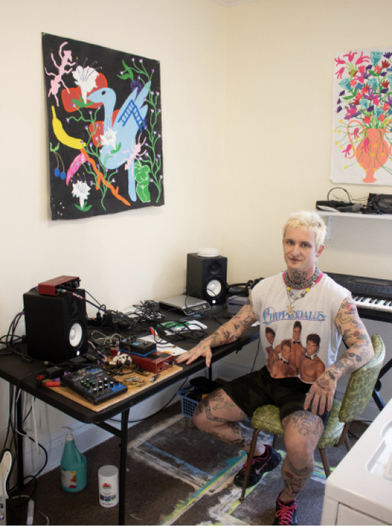 Rabalais seated at a workstation dedicated to another of his passions: music