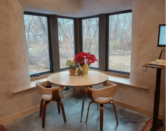 A close-up of the dining area. Note the insulative, thermally massive straw bale walls, most apparent in the window well. Photo courtesy of Adrienne Stolwyk.