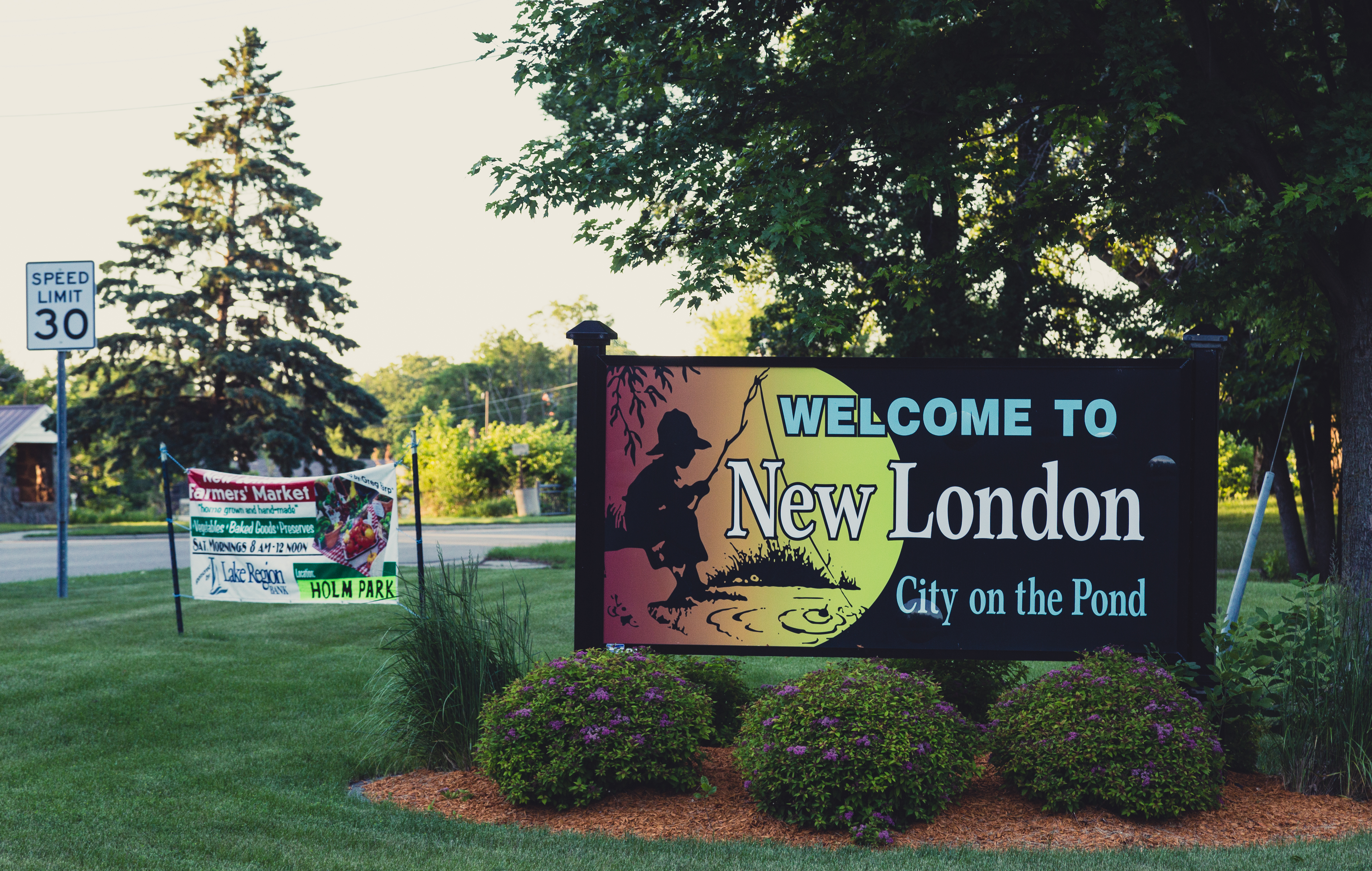 A sign in front of a lawn