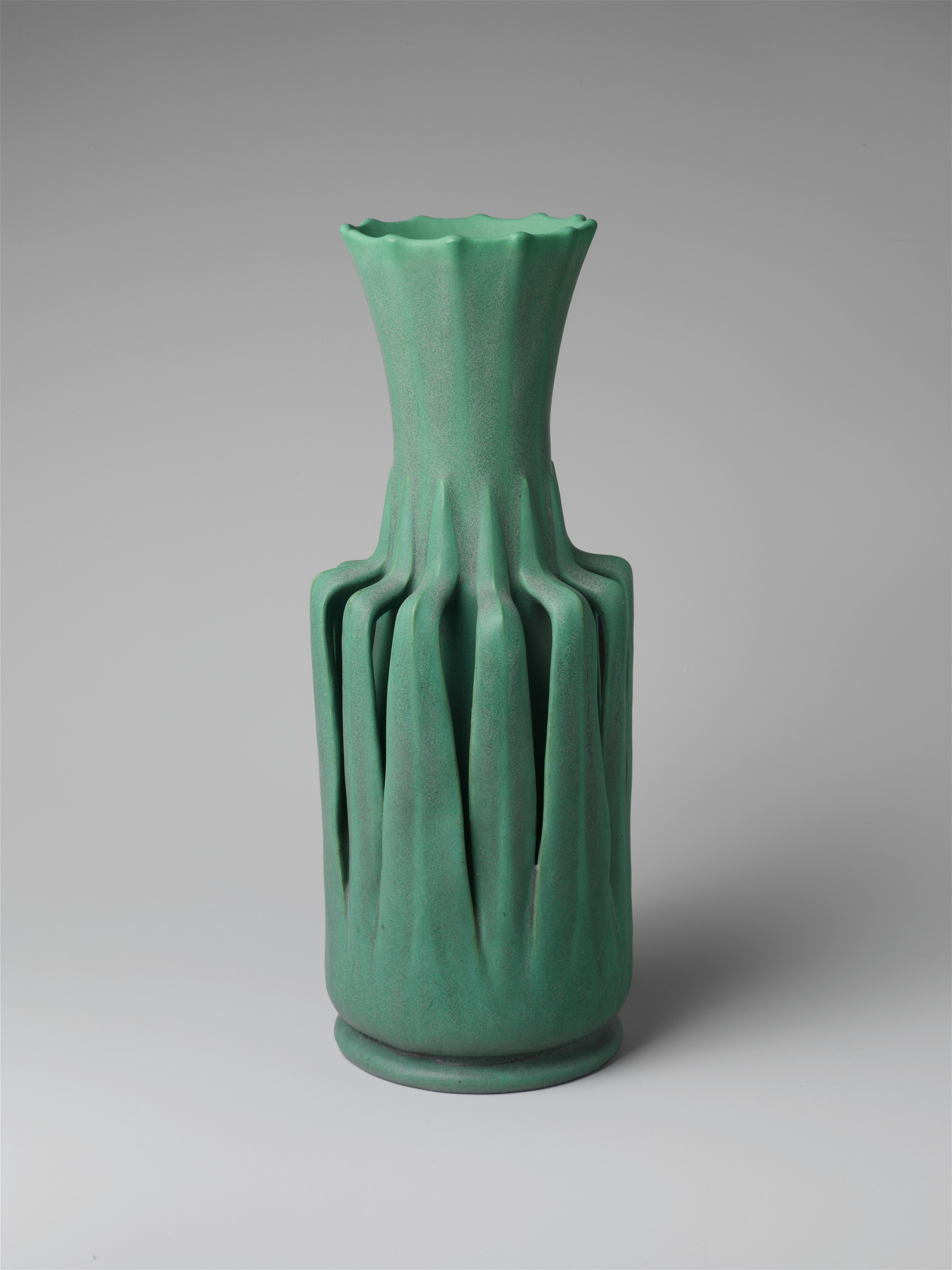 A green vase with a curved neck