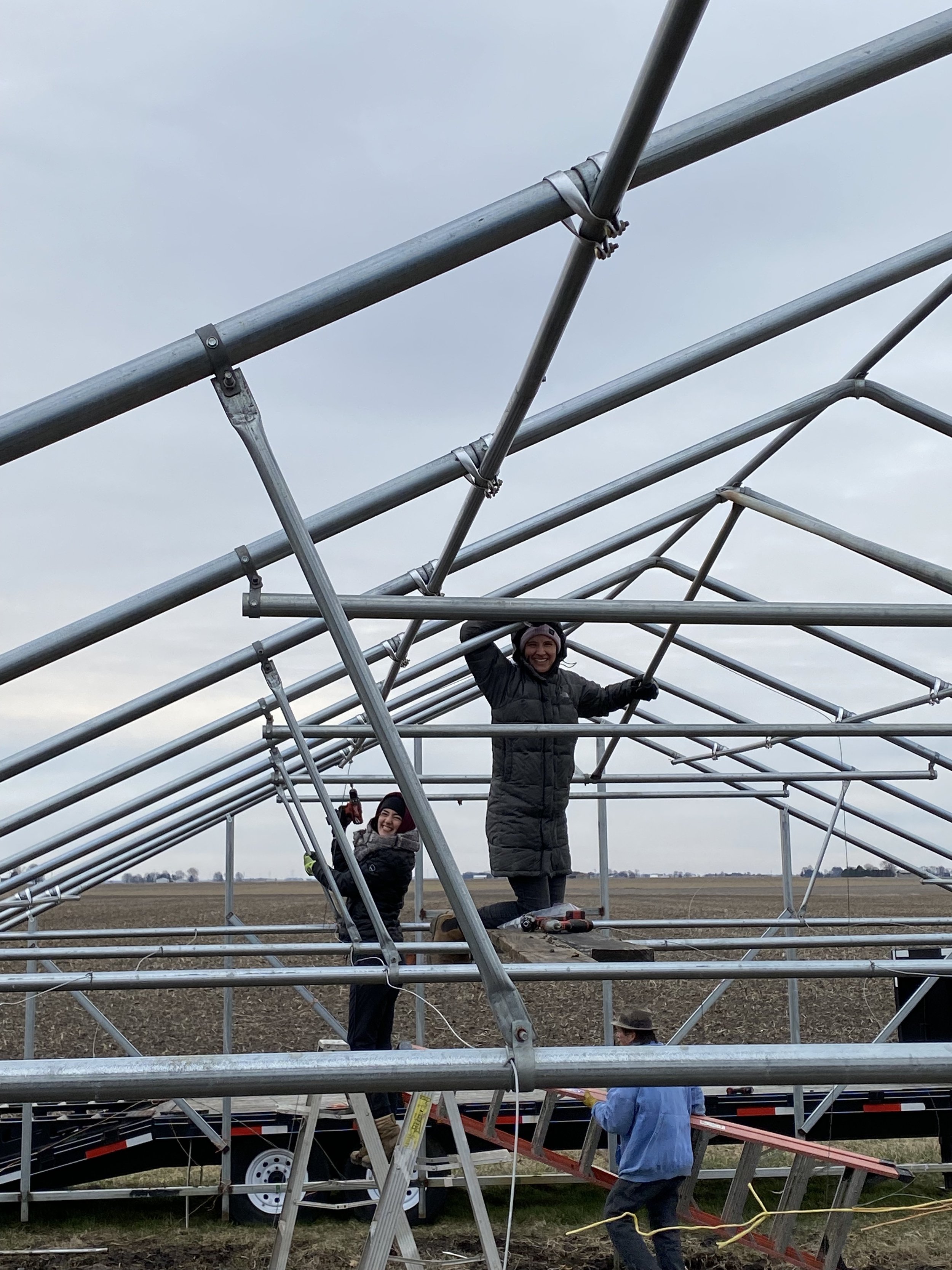 A group of people standing on a metal structure