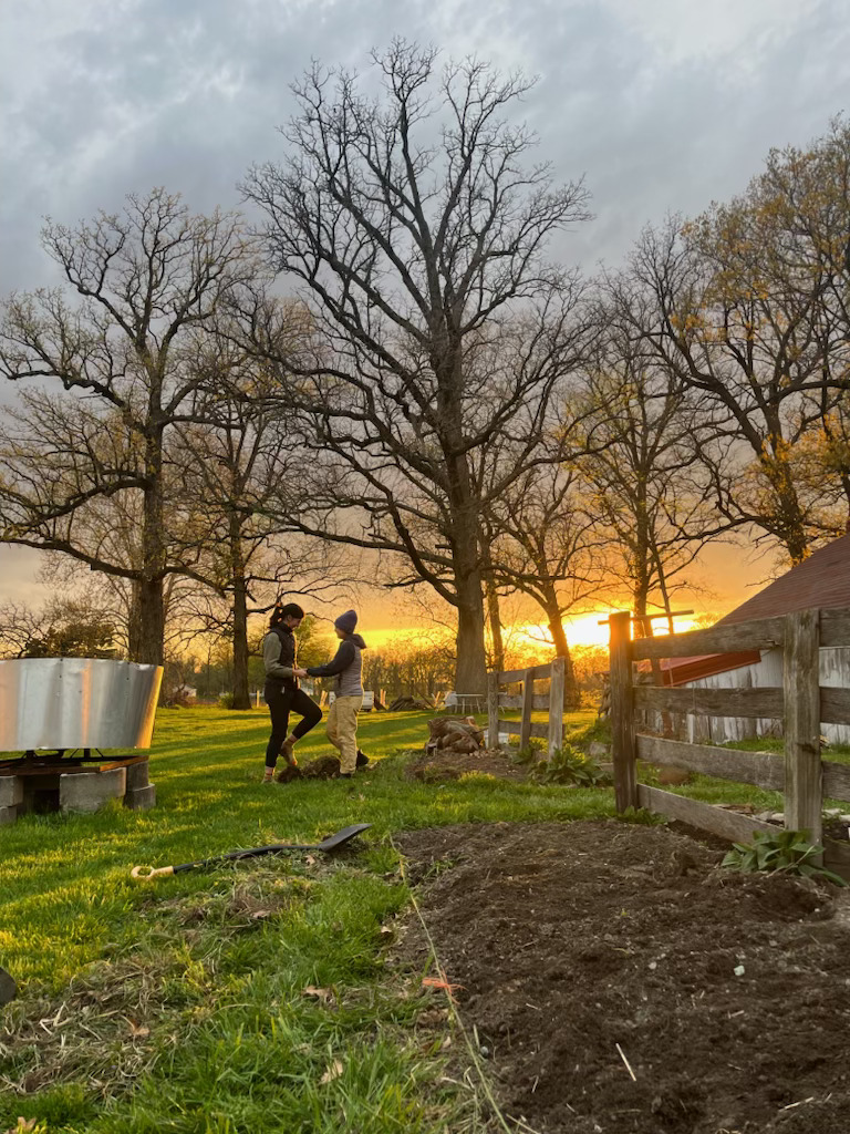 A couple of people walking in a yard