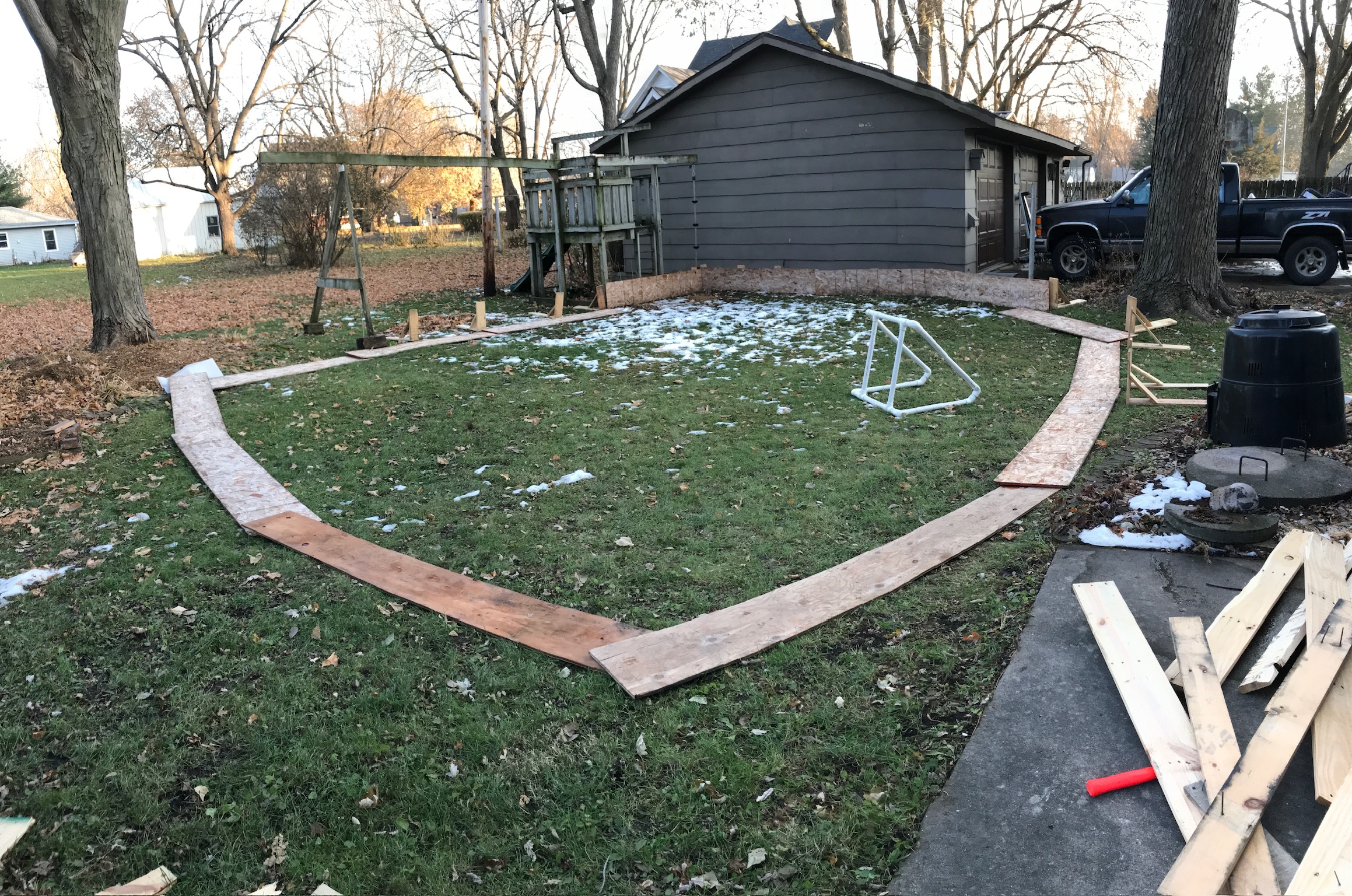 A backyard with a house and a garage