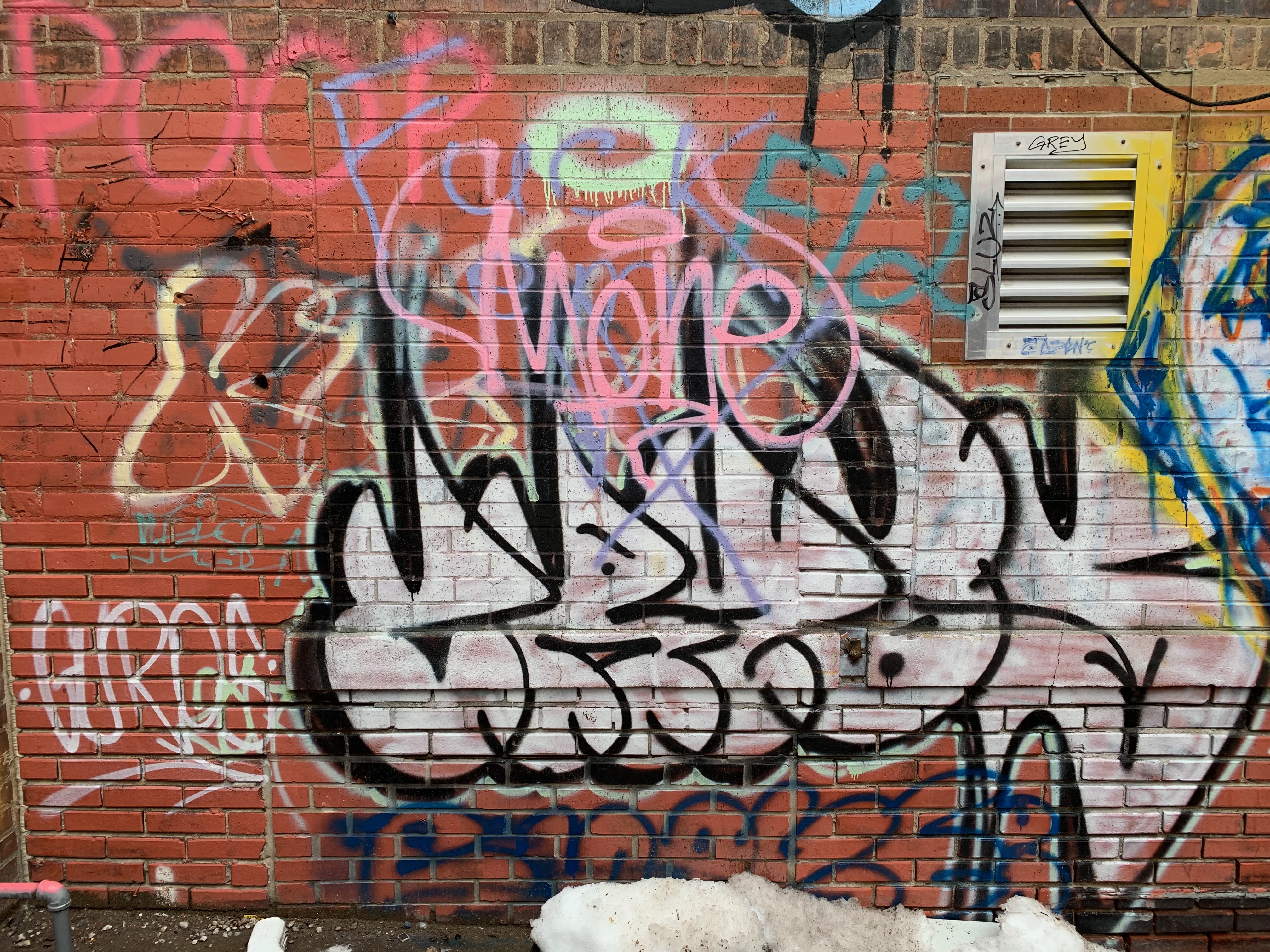 A brick wall with graffiti