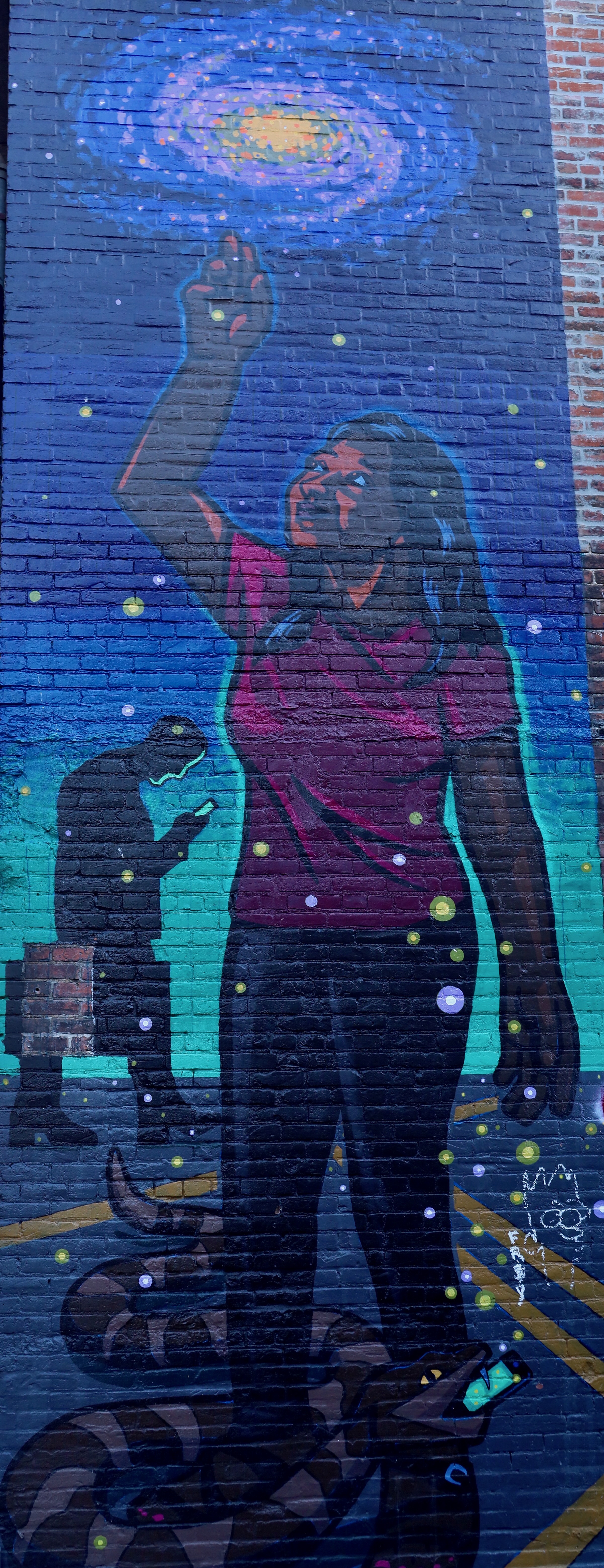 A mural of a woman pointing at a galaxy